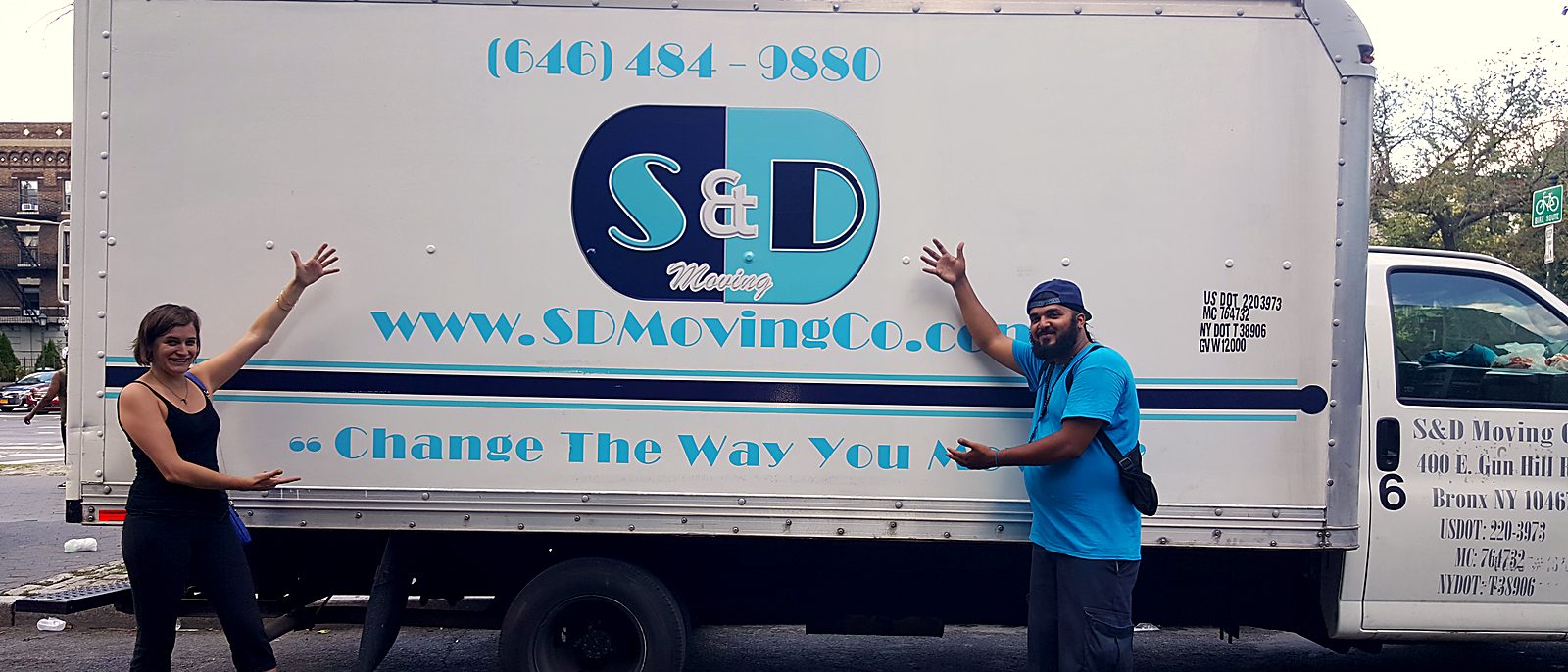 An S&D customer and mover cheering beside the S&D truck